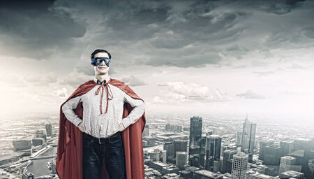 Young confident man in mask and capeの写真素材