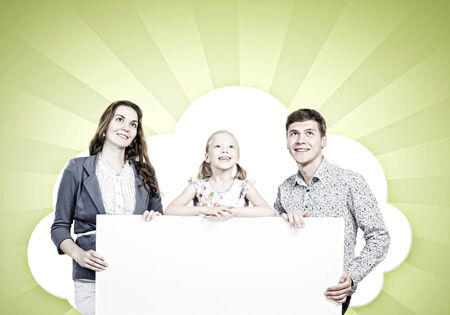 Young happy family with white blank banner  Place for textの写真素材