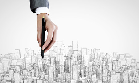 Close up of male hand drawing construction projectの写真素材