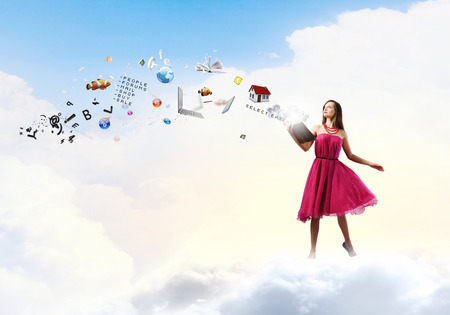 Young woman in rd dress reading bookの写真素材