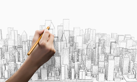 Close up of female hand drawing construction projectの写真素材