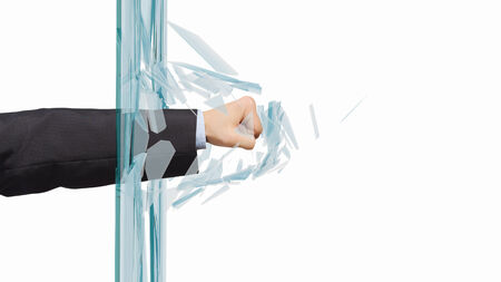 Close up of male fist breaking glass with punchの写真素材