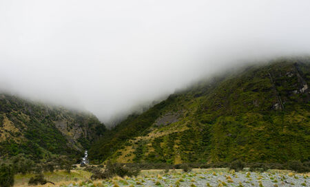 Natural landscape of green mountains and white fogの写真素材