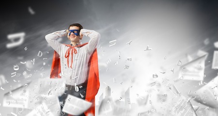 Young man in costume closing ears with palmsの写真素材