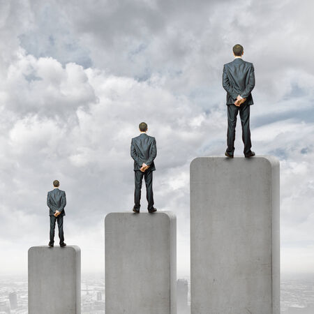 Businessman standing on top of graph barの写真素材