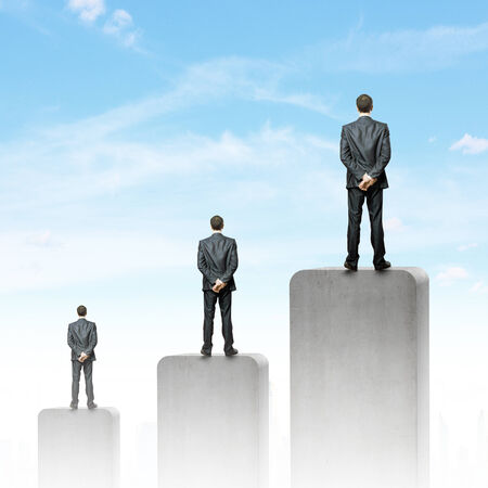 Businessman standing on top of graph barの写真素材