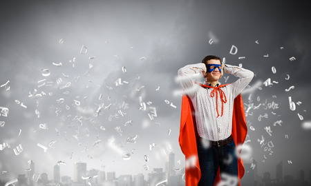 Young man in costume closing ears with palmsの写真素材