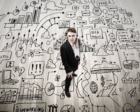 Top view of young businessman with tie around headの写真素材