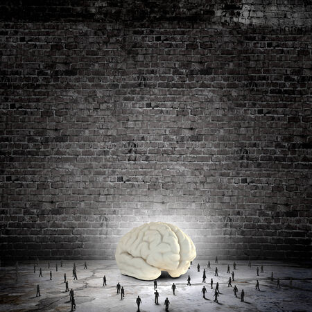 Huge human brain and many little businesspeople aroundの写真素材