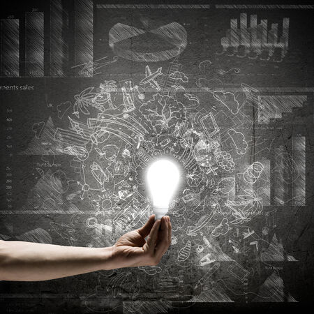 Conceptual image with light bulb diagrams and graphsの写真素材