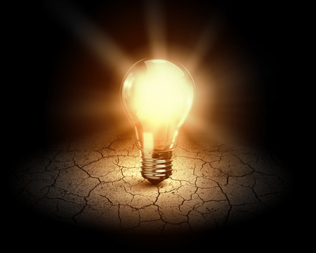 Conceptual image of light bulb on desert surfaceの写真素材