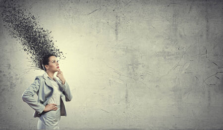 Young troubled businesswoman thinking over the ideasの写真素材