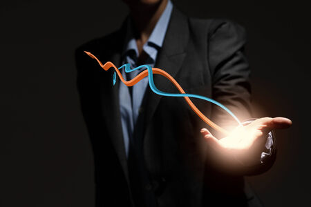 Close up of businesswoman holding graphs in handの写真素材