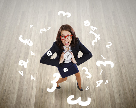 Top view of excited businesswoman holding alarm clockの写真素材