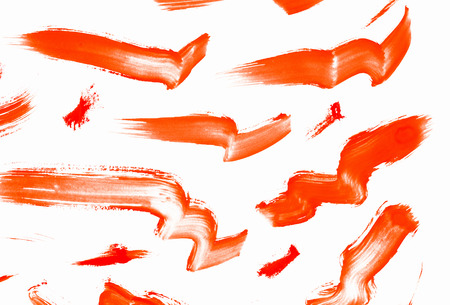 Abstract smears of orange paint on white backgroundの写真素材