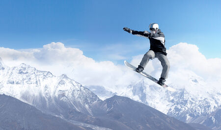 Snowboarder making high jump in clear blue skyの写真素材