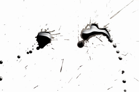 Abstract image with splashes of black paint on white backgroundの写真素材