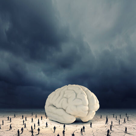 Huge human brain and many little businesspeople aroundの写真素材