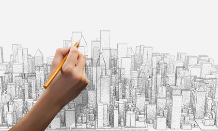 Close up of female hand drawing construction projectの写真素材