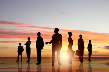 Silhouettes of business people standing in lineの写真素材