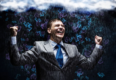 Cheerful businessman with hands up celebrating successの写真素材