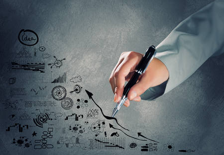 Close up of hand drawing business sketches on cement wallの写真素材