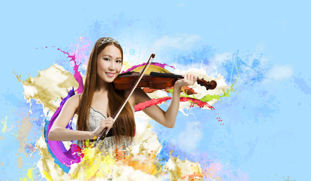 Young pretty asian woman playing violin. Young talentの写真素材