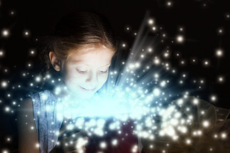 Happy surprised girl opening Christmas present boxの写真素材