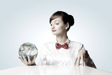 Young smiling woman holding Earth planet in hand.   の写真素材