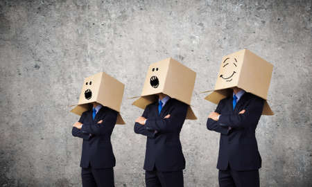Unrecognizable business people with carton boxes on headの写真素材