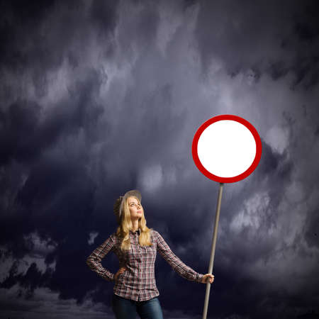 Young girl in casual with white banner. Place for textの写真素材