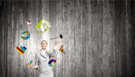 Young pretty businesswoman juggling with white balls. の写真素材
