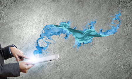 Close up of human hands holding tablet pcの写真素材