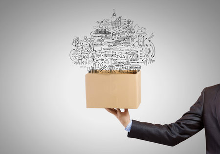 Man holding carton box with business sketches
