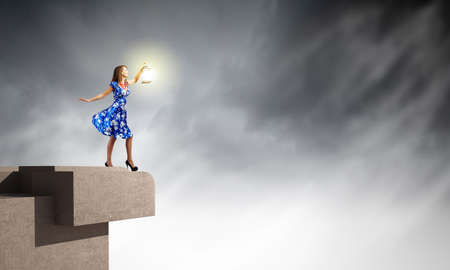 Young woman in blue dress with lanternの写真素材