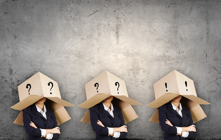 Business people with carton boxes on headの写真素材