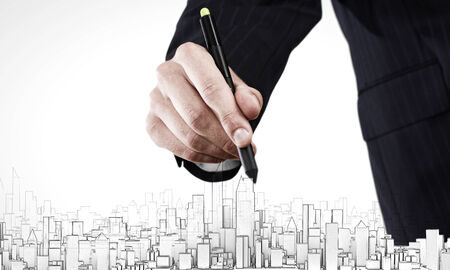 Close up of human hand drawing construction projectの写真素材