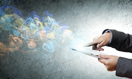 Close up of human hands holding tablet pc