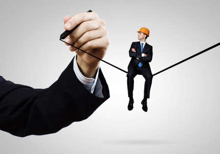 Handsome man engineer sitting on drawn lineの写真素材