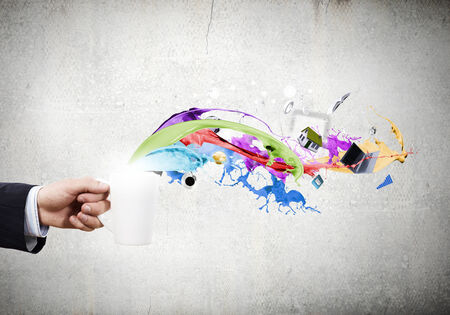 Close up of businessman holding white cup with icons flying outの写真素材