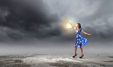 Young woman in blue dress with lanternの写真素材