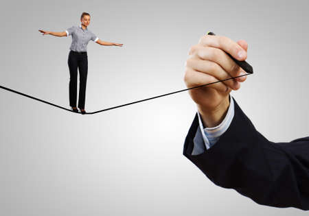 Young confident businesswoman standing on drawn lineの写真素材