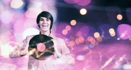 Young handsome man dj holding disco plate