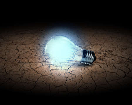 Close up of glowing light bulb in desertの写真素材