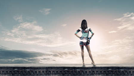 Rear view of young attractive woman in short dressの写真素材