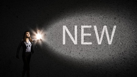 Young pretty businesswoman with lantern in darknessの写真素材