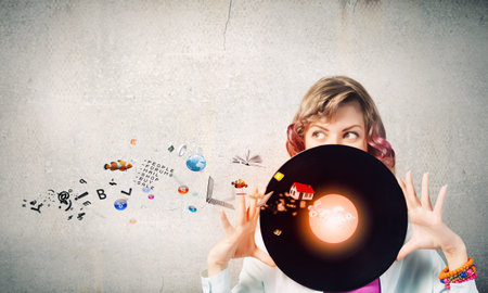 Young woman in casual holding disco plate