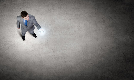 Top view of young businessman using mobile phoneの写真素材