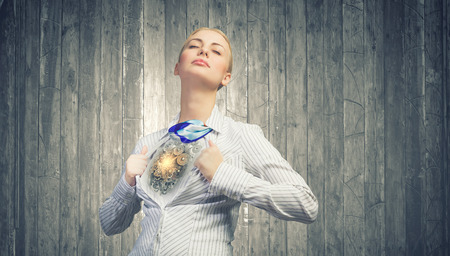 Young woman tearing shirt on chest. Mechanism conceptの写真素材