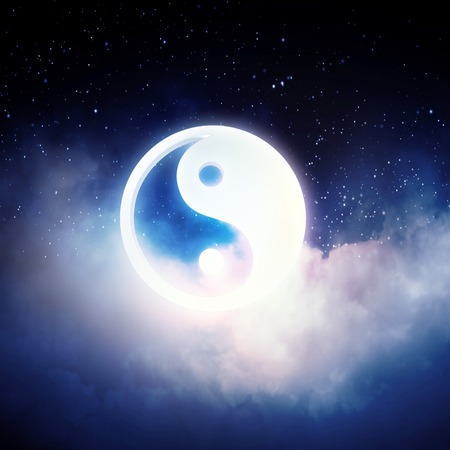 Yin Yang sign in dark night skyの写真素材